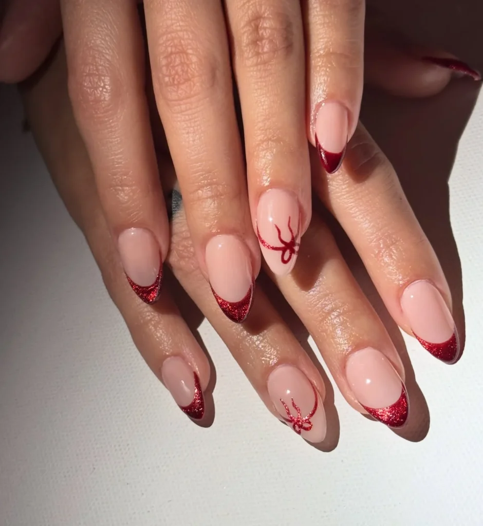 Red glitter French tip Christmas nails with bow accent