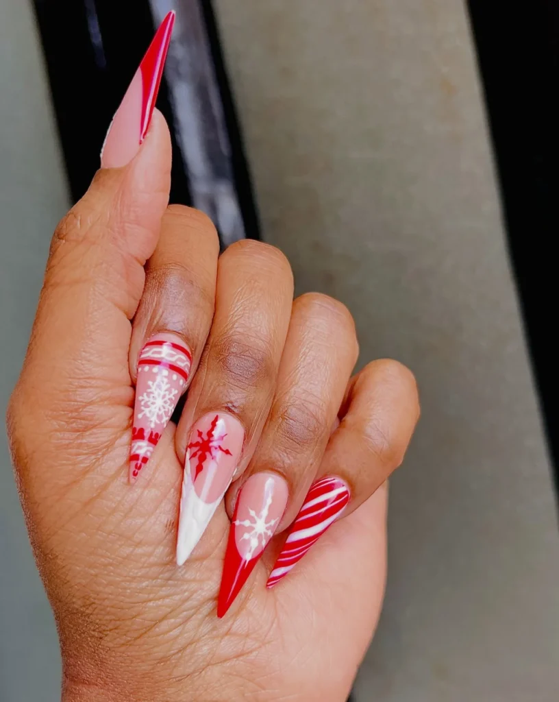 Christmas nails 2026: Stiletto Christmas nails with snowflakes and candy cane stripes