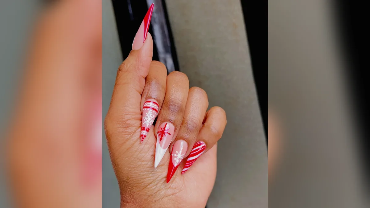 Stiletto Christmas nails with snowflakes and candy cane stripes