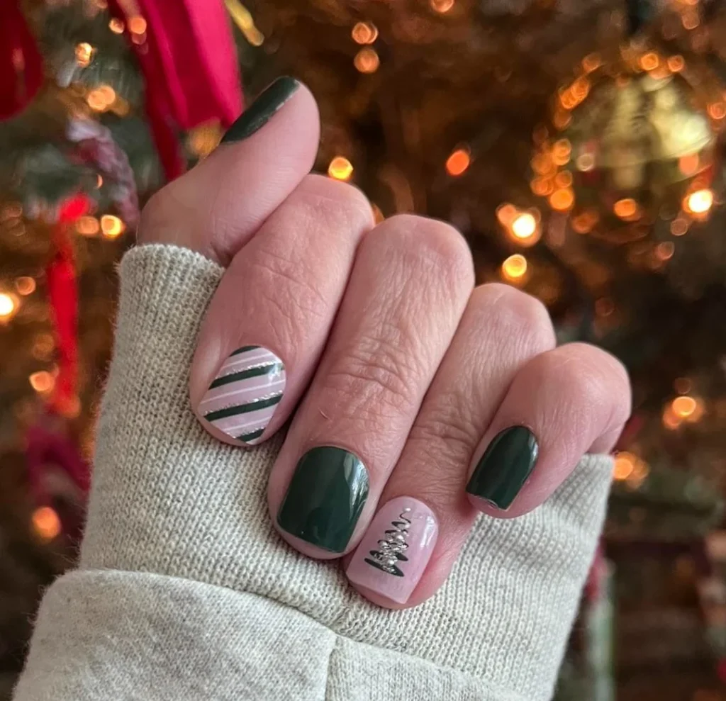 Dark green Christmas nails with striped accent and tree design